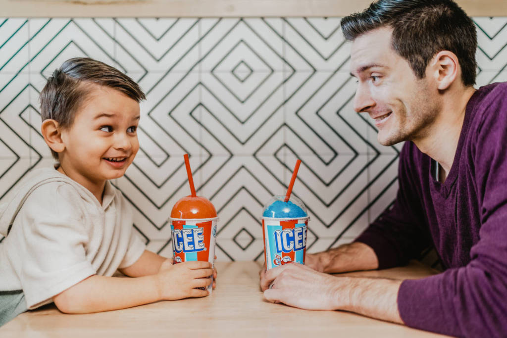 A boy and his father drinking ICEEs