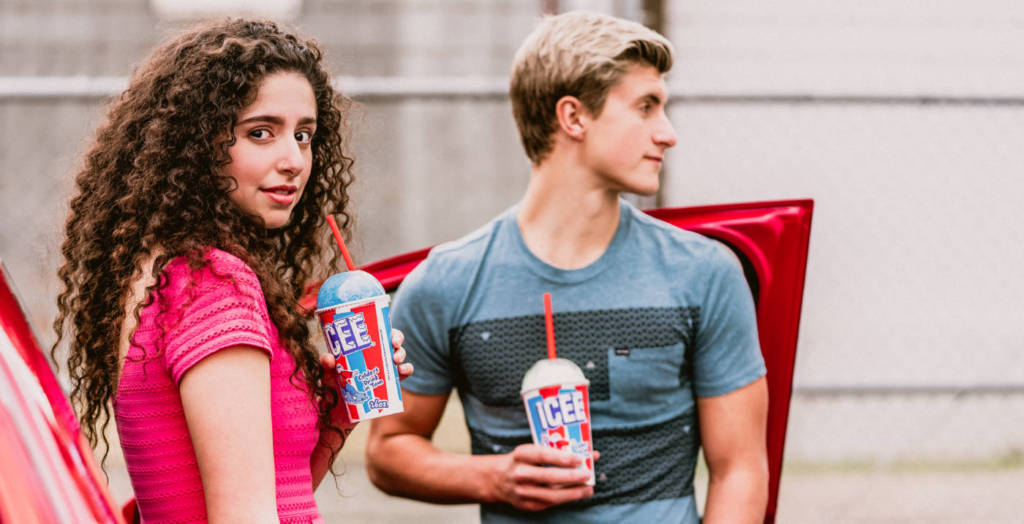A man and a woman drinking ICEEs