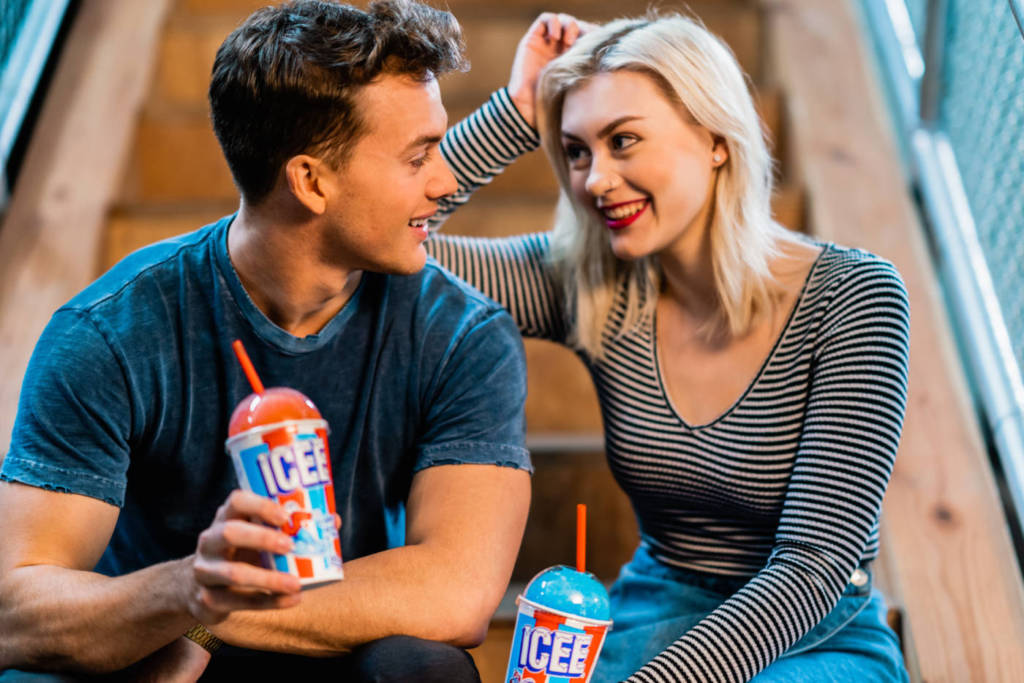 A man and a woman drinking ICEEs